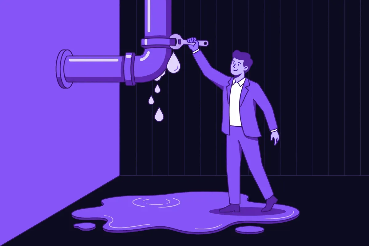 A relieved product manager finally reaching up to tighten a leaking pipe joint directly above a large puddle on the floor, instead of continuing to stare down at the puddle itself
